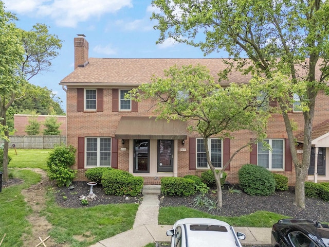 7914 Verandah Ct Unit 61, Powell, OH 43065 - view of front facade with a chimney, roof with shingles, and brick siding
