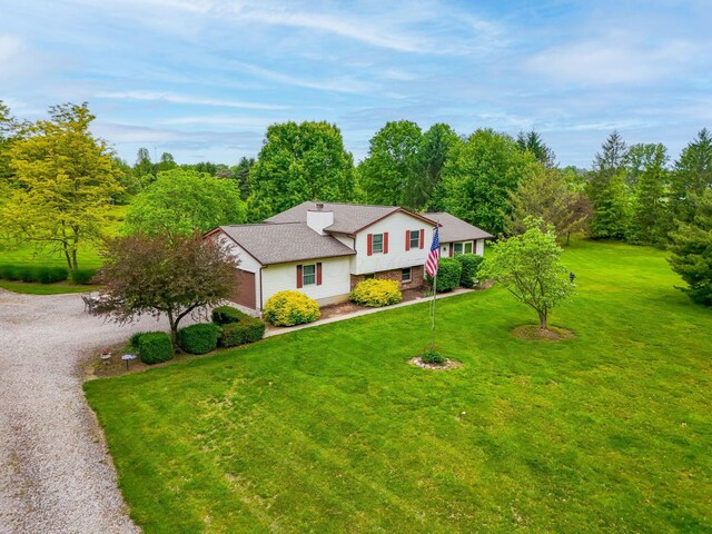 5081 Carters Corner Rd, Sunbury, OH 43074 - split level home featuring driveway, a front yard, a garage, and brick siding