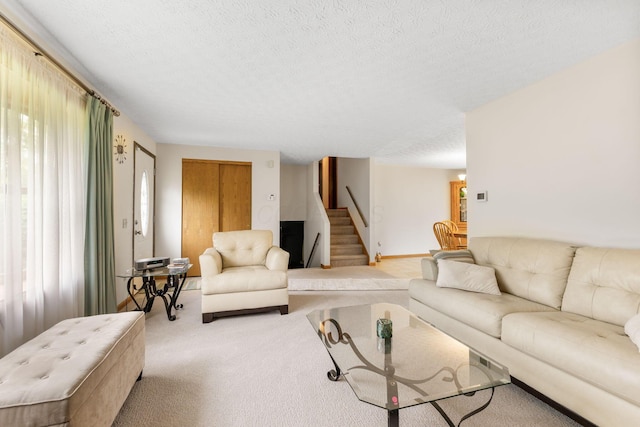 5081 Carters Corner Rd, Sunbury, OH 43074 - carpeted living area featuring stairway and a textured ceiling