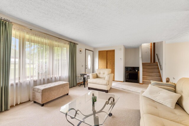 5081 Carters Corner Rd, Sunbury, OH 43074 - living area featuring light carpet, stairs, a fireplace, and a textured ceiling