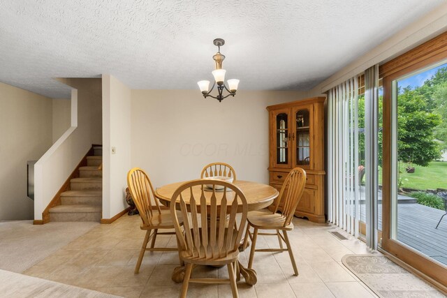 5081 Carters Corner Rd, Sunbury, OH 43074 - dining room with a chandelier, stairs, a textured ceiling, light tile patterned floors, and baseboards