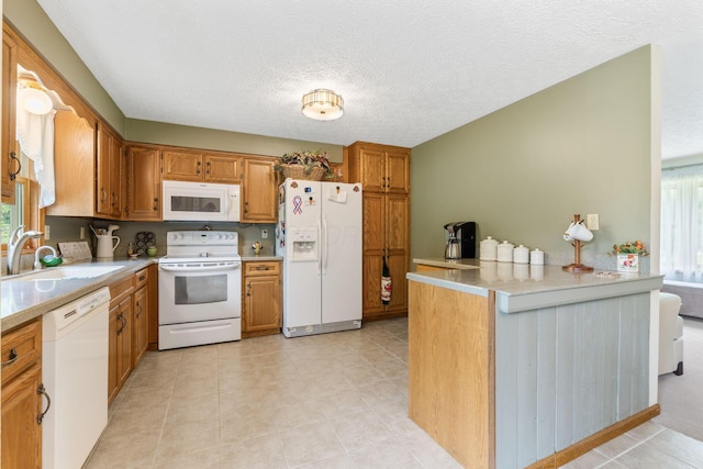 5081 Carters Corner Rd, Sunbury, OH 43074 - kitchen with white appliances, a sink, brown cabinetry, light countertops, and a textured ceiling
