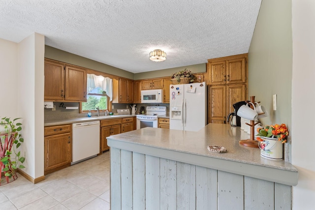 5081 Carters Corner Rd, Sunbury, OH 43074 - kitchen featuring white appliances, a peninsula, light tile patterned floors, brown cabinetry, and a textured ceiling