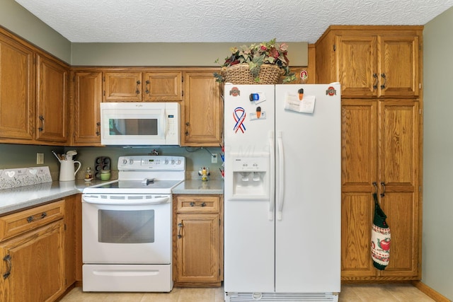 5081 Carters Corner Rd, Sunbury, OH 43074 - kitchen featuring white appliances, brown cabinetry, light countertops, and light tile patterned flooring