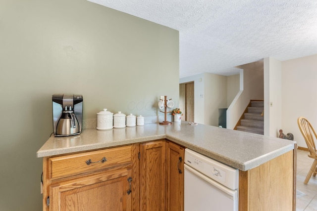 5081 Carters Corner Rd, Sunbury, OH 43074 - kitchen with white dishwasher, a textured ceiling, light countertops, and light tile patterned floors