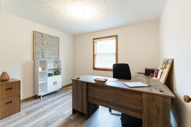 5081 Carters Corner Rd, Sunbury, OH 43074 - home office featuring light wood-style floors, a textured ceiling, and baseboards
