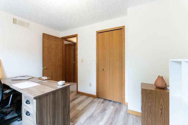 5081 Carters Corner Rd, Sunbury, OH 43074 - home office featuring light wood-style floors, baseboards, and a textured ceiling