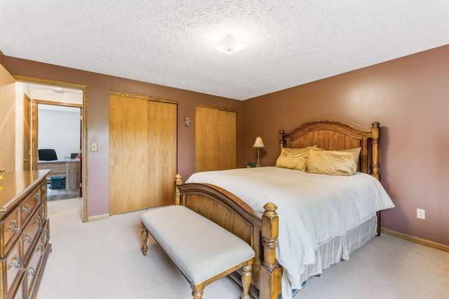 5081 Carters Corner Rd, Sunbury, OH 43074 - bedroom with two closets, light colored carpet, a textured ceiling, and baseboards