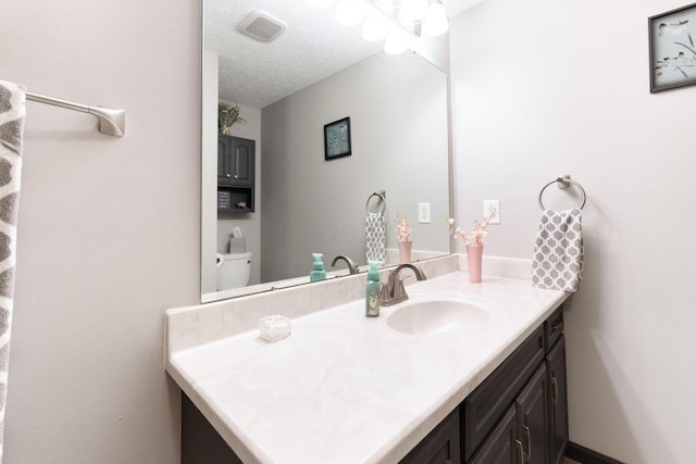 5081 Carters Corner Rd, Sunbury, OH 43074 - bathroom with vanity, a textured ceiling, and toilet