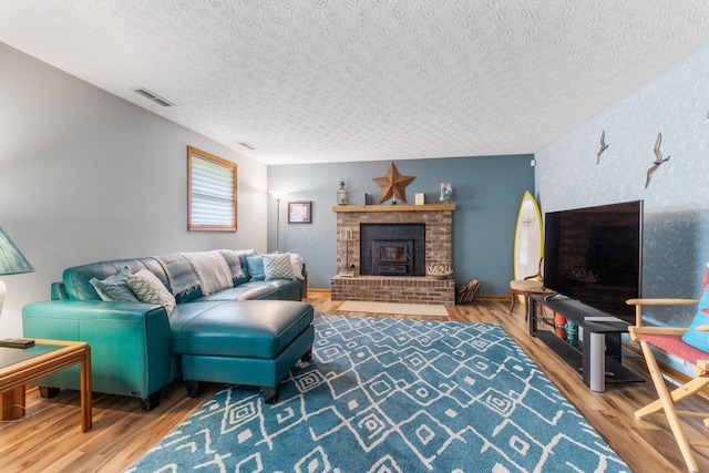 5081 Carters Corner Rd, Sunbury, OH 43074 - living room featuring a textured ceiling, wood finished floors, and a fireplace