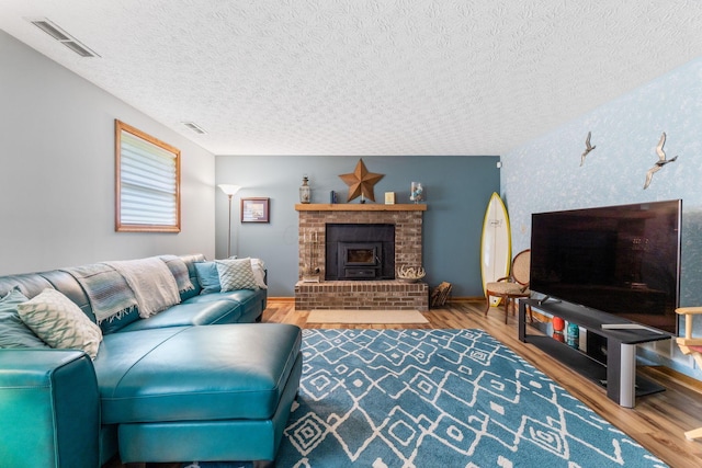 5081 Carters Corner Rd, Sunbury, OH 43074 - living room featuring a textured ceiling, wood finished floors, and a fireplace