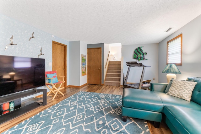 5081 Carters Corner Rd, Sunbury, OH 43074 - living area with wood finished floors, a textured ceiling, stairway, baseboards, and wallpapered walls