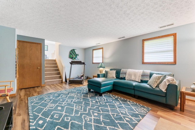 5081 Carters Corner Rd, Sunbury, OH 43074 - living area with stairway, wood finished floors, and a textured ceiling