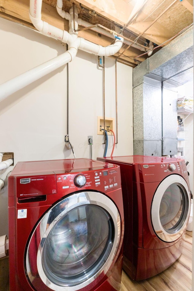 5081 Carters Corner Rd, Sunbury, OH 43074 - laundry area with separate washer and dryer and wood finished floors