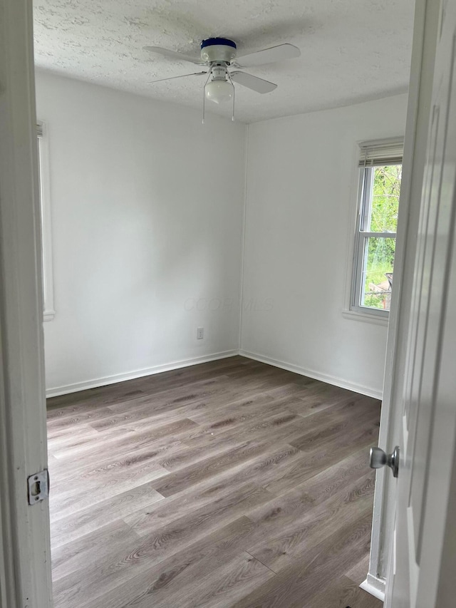 101 N James Rd, Columbus, OH 43213 - spare room featuring a ceiling fan, wood finished floors, baseboards, and a textured ceiling