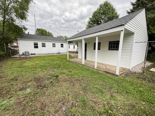 101 N James Rd, Columbus, OH 43213 - back of house featuring cooling unit, a yard, and a shingled roof