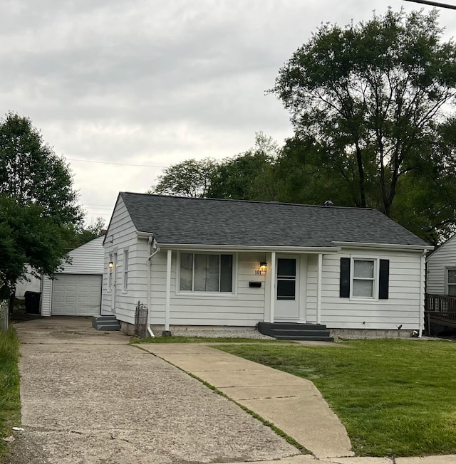 101 N James Rd, Columbus, OH 43213 - view of front of property with an outbuilding, a front lawn, roof with shingles, and concrete driveway