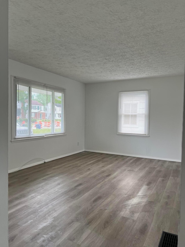 101 N James Rd, Columbus, OH 43213 - spare room with plenty of natural light, wood finished floors, a textured ceiling, and baseboards