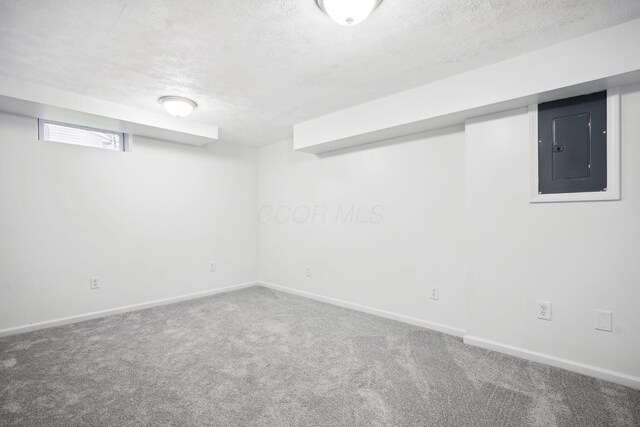 3783 Laguna Dr, Columbus, OH 43232 - basement with electric panel, a textured ceiling, carpet, and baseboards