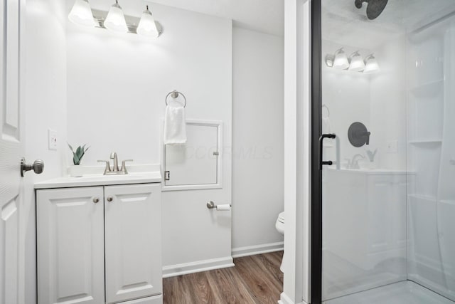 3783 Laguna Dr, Columbus, OH 43232 - full bathroom with a stall shower, wood finished floors, toilet, vanity, and baseboards