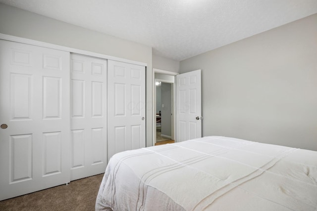 3783 Laguna Dr, Columbus, OH 43232 - bedroom with dark colored carpet, a closet, and a textured ceiling