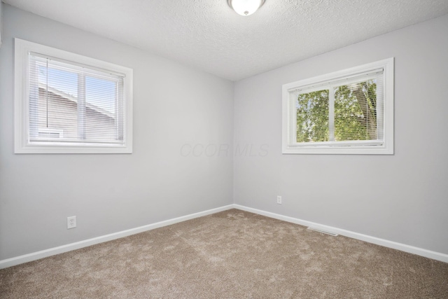 3783 Laguna Dr, Columbus, OH 43232 - carpeted empty room featuring baseboards and a textured ceiling