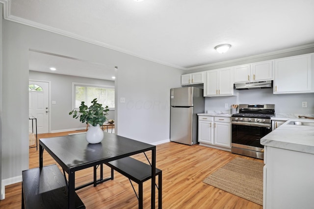 3783 Laguna Dr, Columbus, OH 43232 - kitchen with stainless steel appliances, under cabinet range hood, light countertops, ornamental molding, and white cabinetry