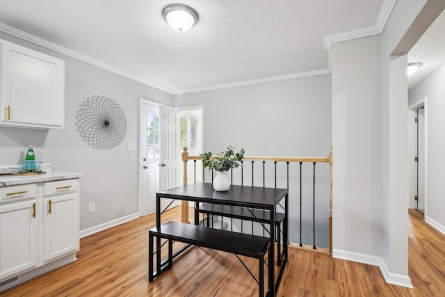 3783 Laguna Dr, Columbus, OH 43232 - dining room featuring light wood-type flooring, ornamental molding, and baseboards
