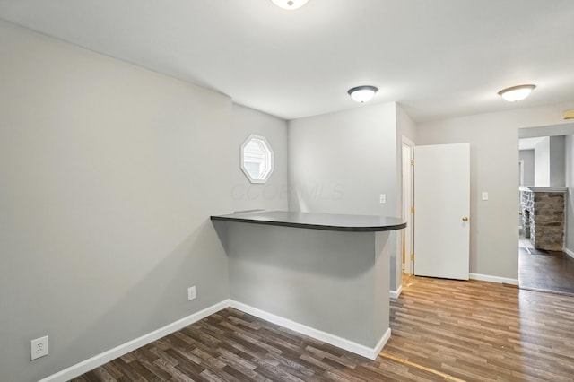 760-762 Kelton Ave, Columbus, OH 43205 - kitchen featuring dark wood-type flooring, baseboards, dark countertops, and a peninsula
