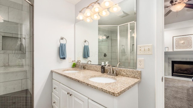 2145 Welsh Hills Rd NE, Granville, OH 43023 - bathroom featuring double vanity, a stall shower, ceiling fan, and a high end fireplace