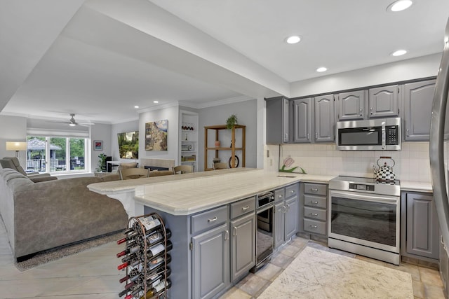 4945 Walnut Rd Unit 6, Buckeye Lake, OH 43008 - kitchen featuring stainless steel appliances, gray cabinets, a peninsula, light countertops, and backsplash