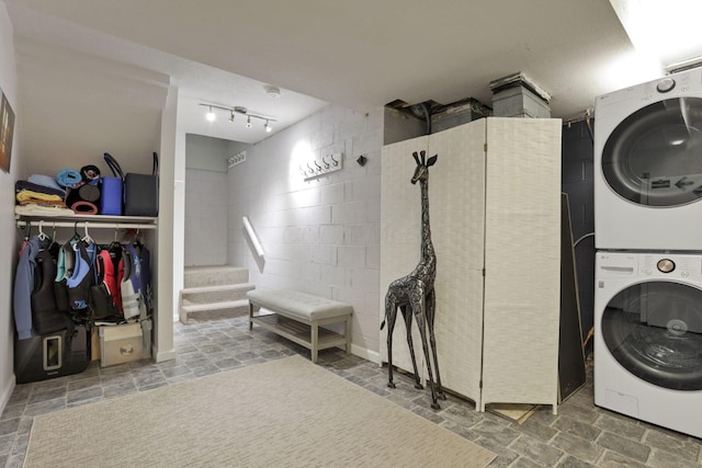 4945 Walnut Rd Unit 6, Buckeye Lake, OH 43008 - laundry room with stacked washer / drying machine, concrete block wall, and stone finish flooring