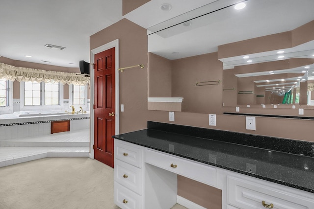 736 Eton St, Marion, OH 43302 - bathroom with vanity, a garden tub, and recessed lighting