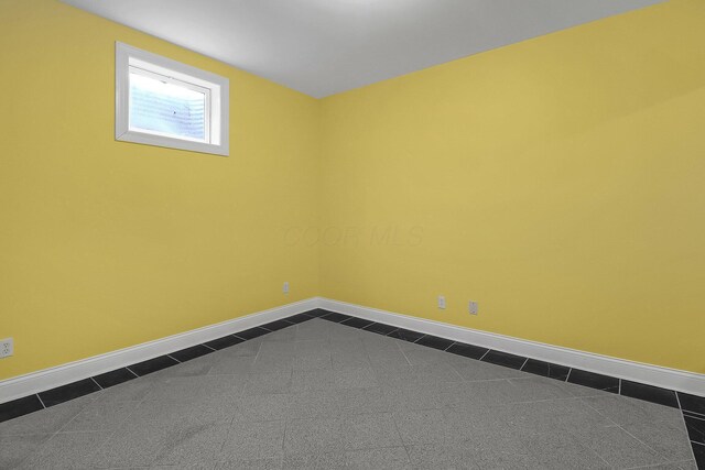 736 Eton St, Marion, OH 43302 - spare room featuring dark tile patterned floors and baseboards