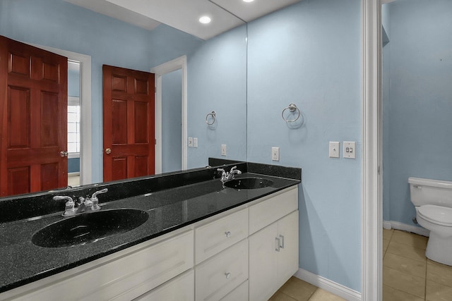 736 Eton St, Marion, OH 43302 - full bathroom featuring toilet, double vanity, tile patterned flooring, and baseboards
