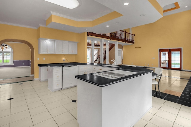 736 Eton St, Marion, OH 43302 - kitchen with light tile patterned floors, dishwasher, a peninsula, ornamental molding, and a tray ceiling