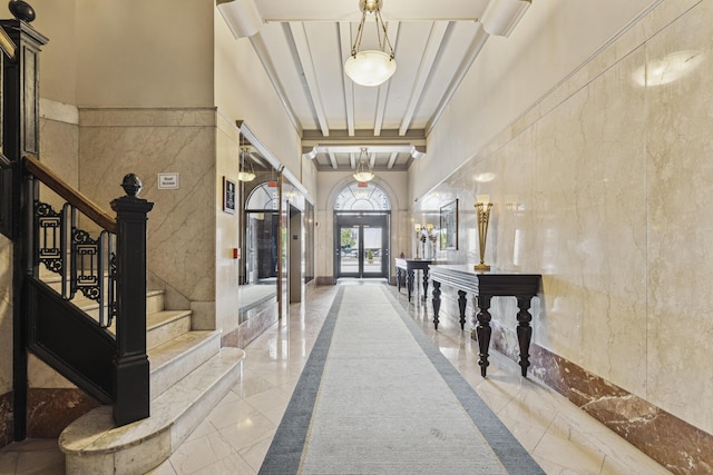 145 N High St Unit 300, Columbus, OH 43215 - entrance foyer featuring marble tiled floors, stairs, a towering ceiling, and tile walls