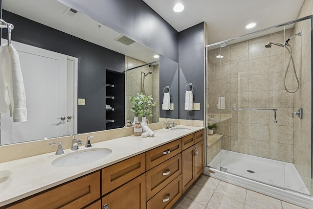 145 N High St Unit 300, Columbus, OH 43215 - bathroom featuring double vanity, a shower stall, and tile patterned floors