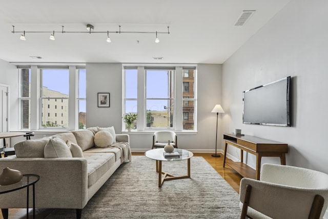 145 N High St Unit 300, Columbus, OH 43215 - living area with track lighting, wood finished floors, and baseboards