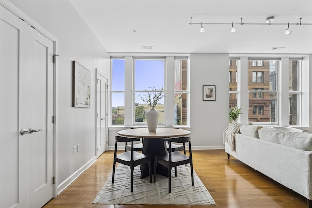 145 N High St Unit 300, Columbus, OH 43215 - dining area featuring healthy amount of natural light, baseboards, and wood finished floors