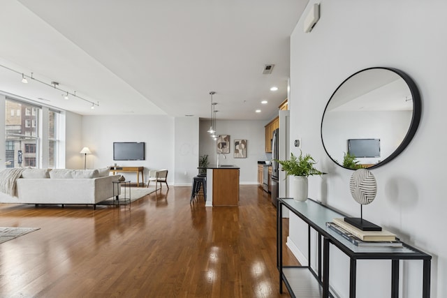 145 N High St Unit 300, Columbus, OH 43215 - living room featuring dark wood finished floors, track lighting, recessed lighting, and baseboards