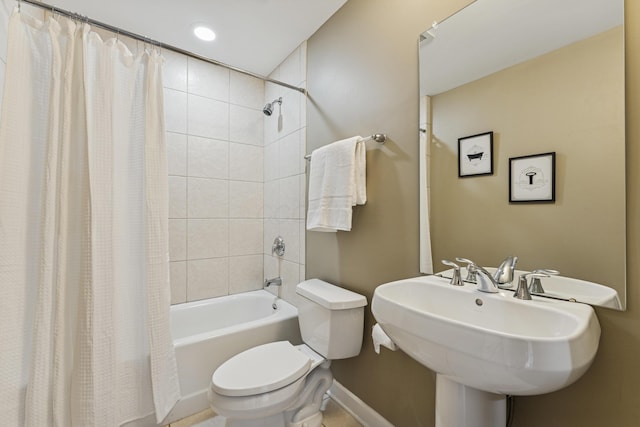 145 N High St Unit 300, Columbus, OH 43215 - bathroom featuring toilet, shower / tub combo with curtain, baseboards, recessed lighting, and a sink