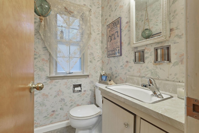 1470 Berkshire Rd, Columbus, OH 43221 - half bathroom with vanity, wallpapered walls, and toilet