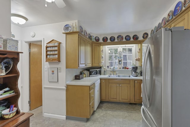 1470 Berkshire Rd, Columbus, OH 43221 - kitchen featuring appliances with stainless steel finishes, light countertops, ceiling fan, and a sink
