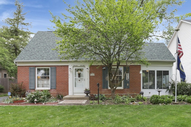 1470 Berkshire Rd, Columbus, OH 43221 - cape cod home with brick siding, roof with shingles, and a front yard