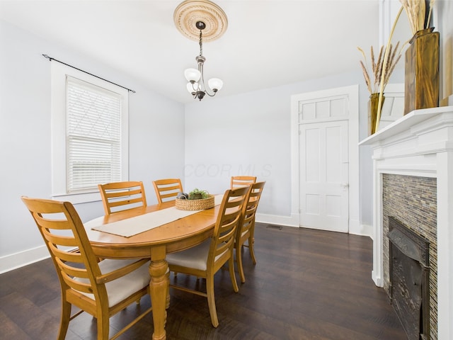 715 N Broad St, Lancaster, OH 43130 - dining area featuring a tile fireplace, dark wood finished floors, baseboards, and a chandelier