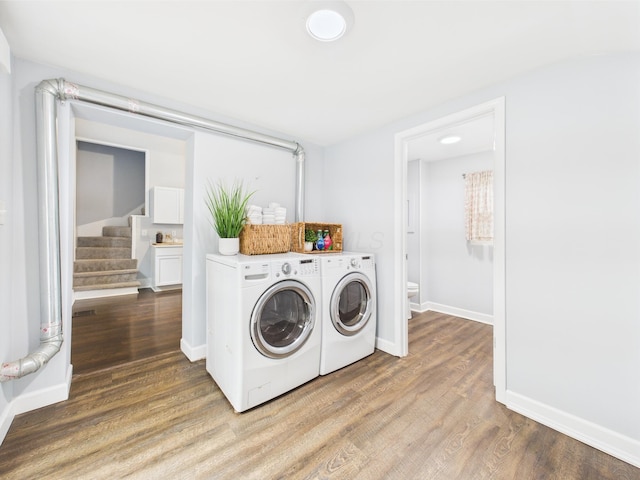 715 N Broad St, Lancaster, OH 43130 - laundry area featuring washing machine and clothes dryer, wood finished floors, and baseboards