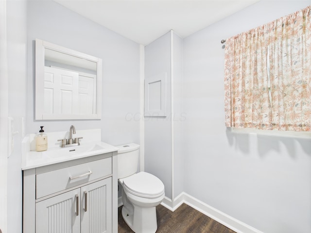 715 N Broad St, Lancaster, OH 43130 - half bath featuring wood finished floors, toilet, vanity, and baseboards