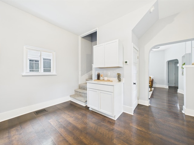 715 N Broad St, Lancaster, OH 43130 - bar featuring arched walkways, stairway, dark wood-style flooring, and baseboards