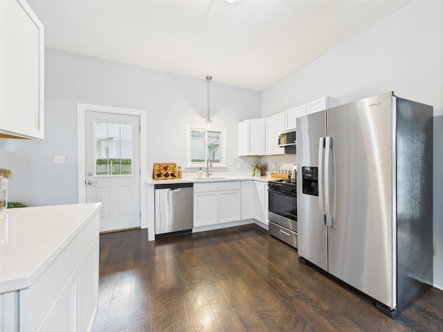 715 N Broad St, Lancaster, OH 43130 - kitchen featuring appliances with stainless steel finishes, a sink, light countertops, white cabinetry, and pendant lighting